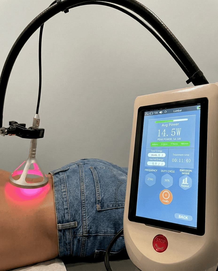 Class IV therapy laser device display showing 14.5 watt output during a treatment session at McAlpine Chiropractic in Holland, MI