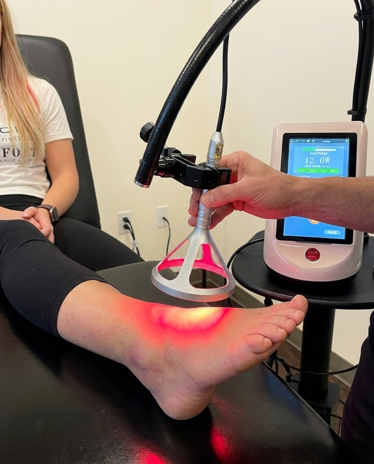 Class IV laser therapy treatment on a patient's foot at McAlpine Chiropractic in Holland, MI