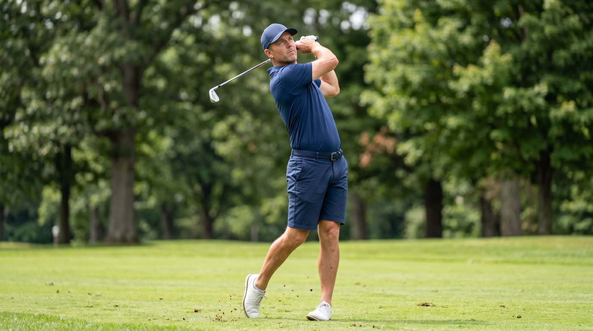 Golfer finishing a full golf swing on a fairway near Holland, Michigan